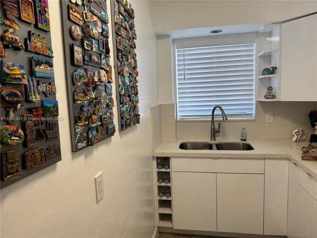 a kitchen with a sink and cabinets