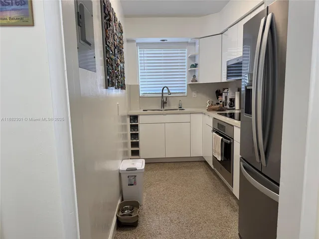 a kitchen with a sink stainless steel appliances and cabinets