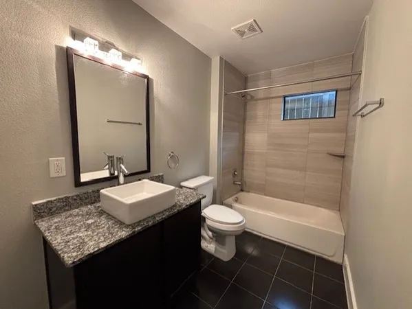 a bathroom with a sink toilet a mirror and shower