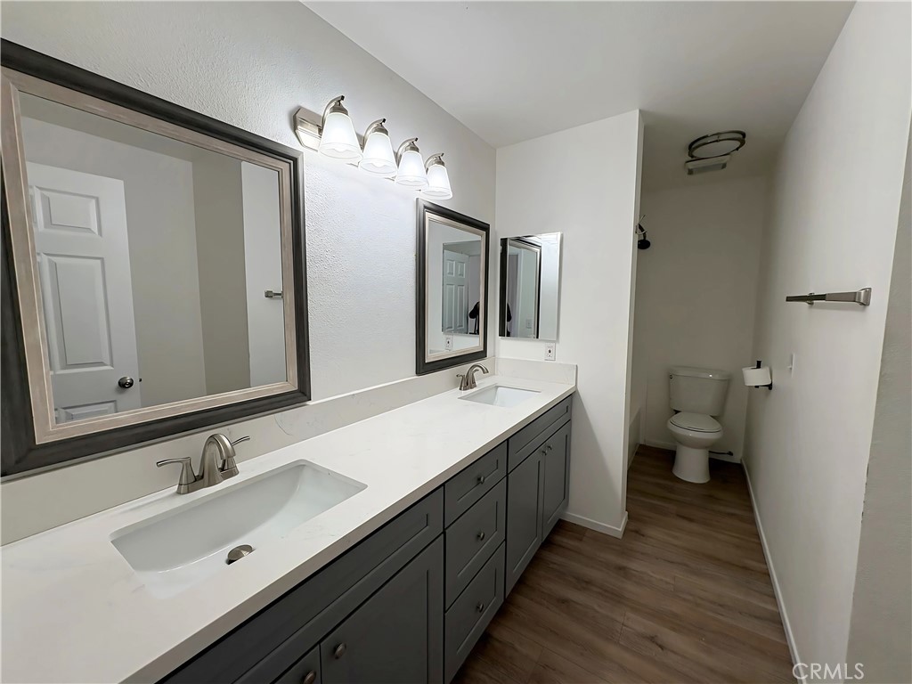 6635 Geranium Place Riverside, CA 92503 - Photo 7 of 15 a bathroom with a double vanity sink and mirror with toilet