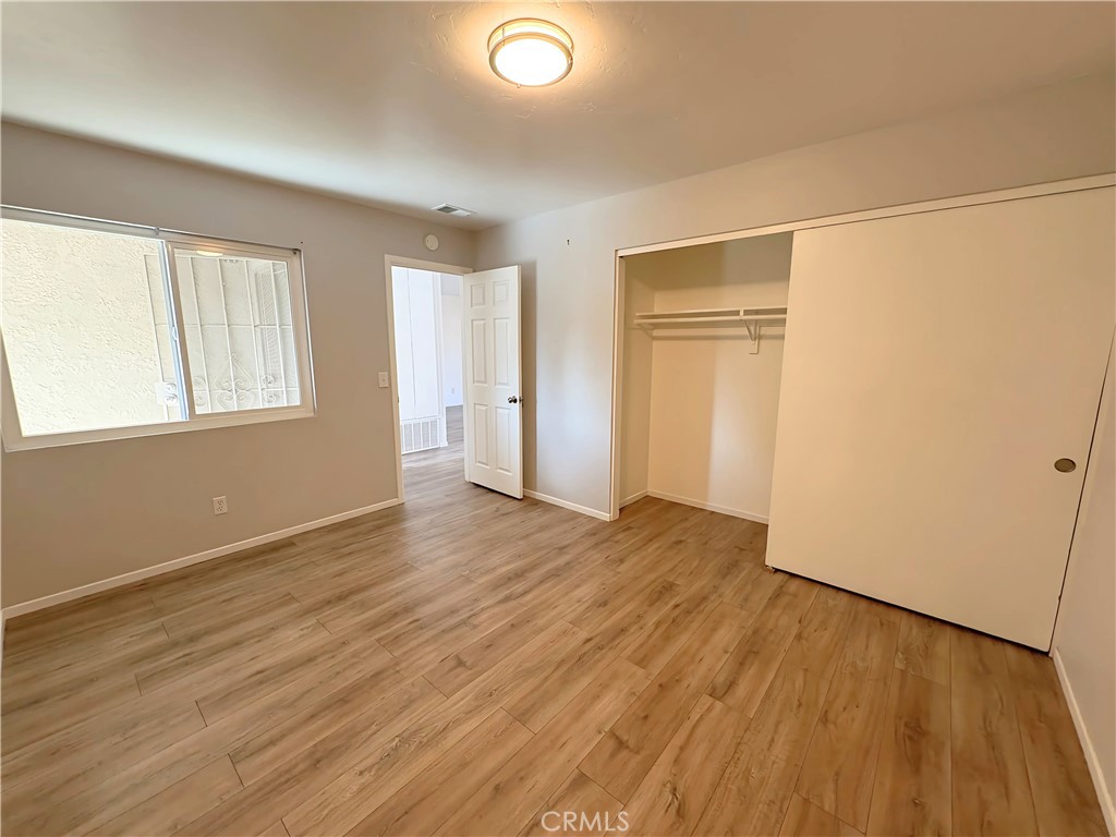 6635 Geranium Place Riverside, CA 92503 - Photo 10 of 15 an empty room with wooden floor and windows