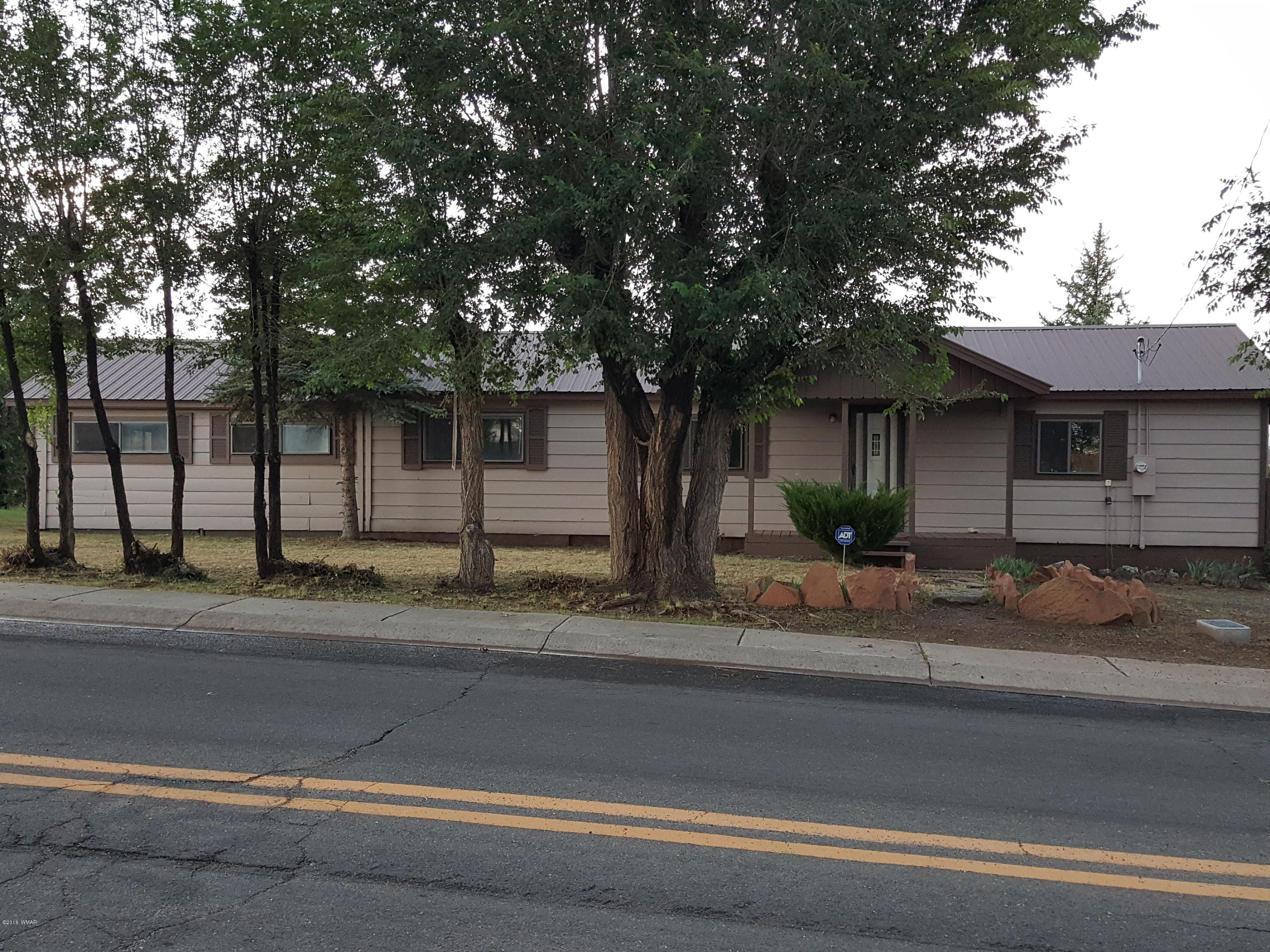 1128 East Maricopa Drive Springerville, AZ 85938 - Photo 1 of 28 a front view of a house with a yard