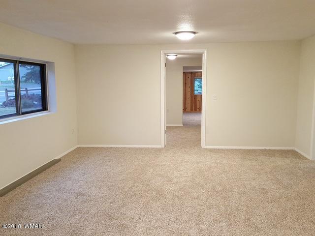 1128 East Maricopa Drive Springerville, AZ 85938 - Photo 11 of 28 an empty room with entrance and windows