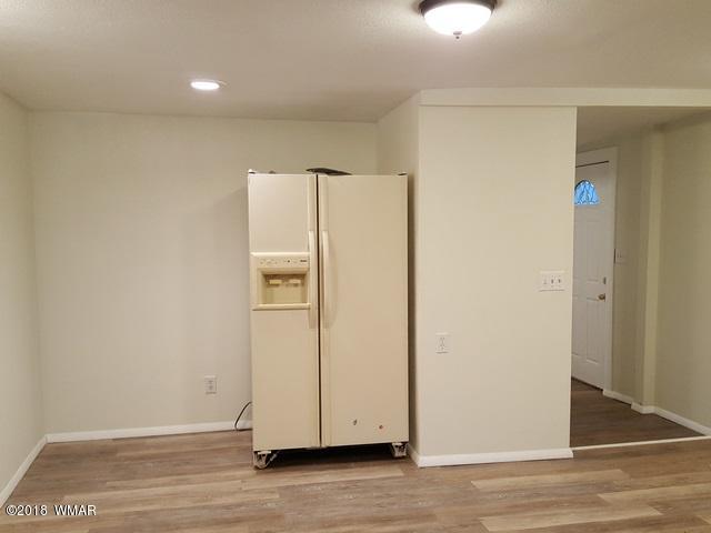 1128 East Maricopa Drive Springerville, AZ 85938 - Photo 14 of 28 an empty room with wooden floor
