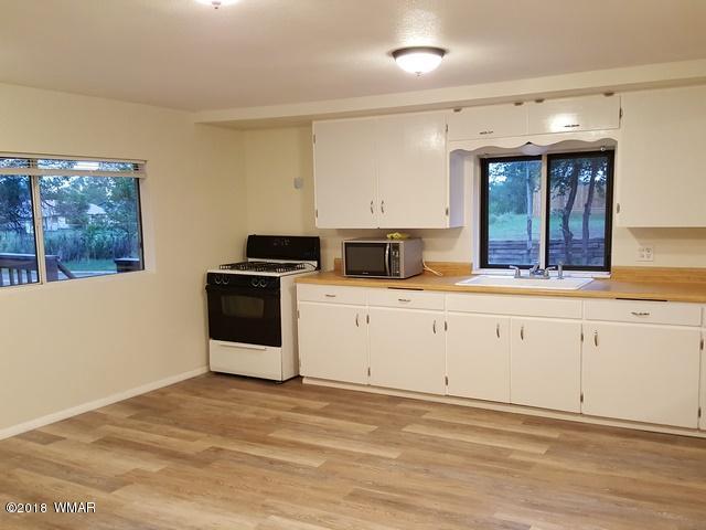 1128 East Maricopa Drive Springerville, AZ 85938 - Photo 15 of 28 a kitchen with granite countertop a sink stainless steel appliances and cabinets
