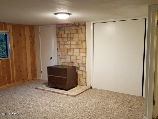 1128 East Maricopa Drive Springerville, AZ 85938 - Photo 19 of 28 an empty room with a cabinet and a flat screen tv