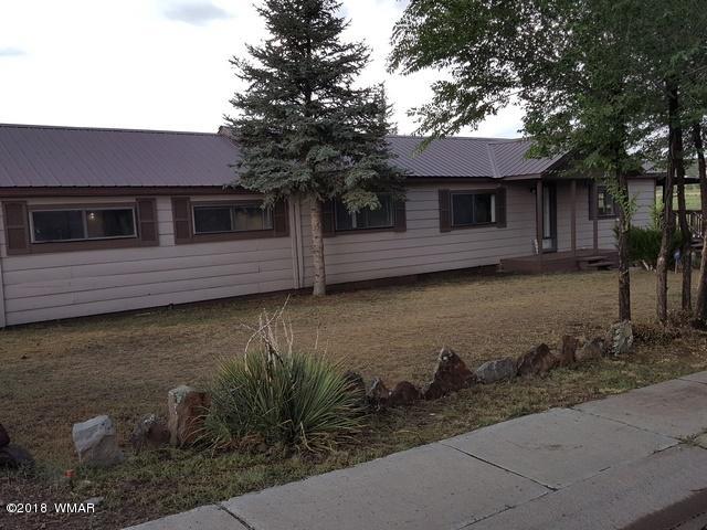 1128 East Maricopa Drive Springerville, AZ 85938 - Photo 2 of 28 a front view of a house with garden