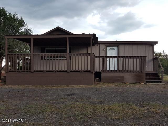 1128 East Maricopa Drive Springerville, AZ 85938 - Photo 6 of 28 a view of a house with wooden fence