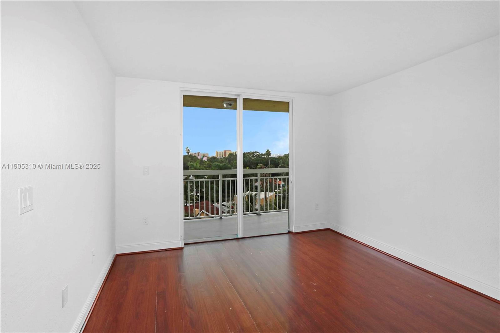 816 Northwest 11th Street, Unit 610 Miami, FL 33136 - Photo 11 of 28 a view of a room with wooden floor and window