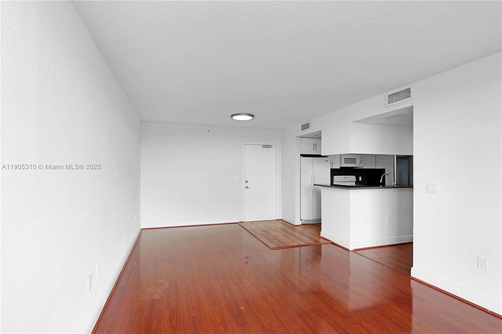 816 Northwest 11th Street, Unit 610 Miami, FL 33136 - Photo 12 of 28 a view of a kitchen with a sink and a refrigerator