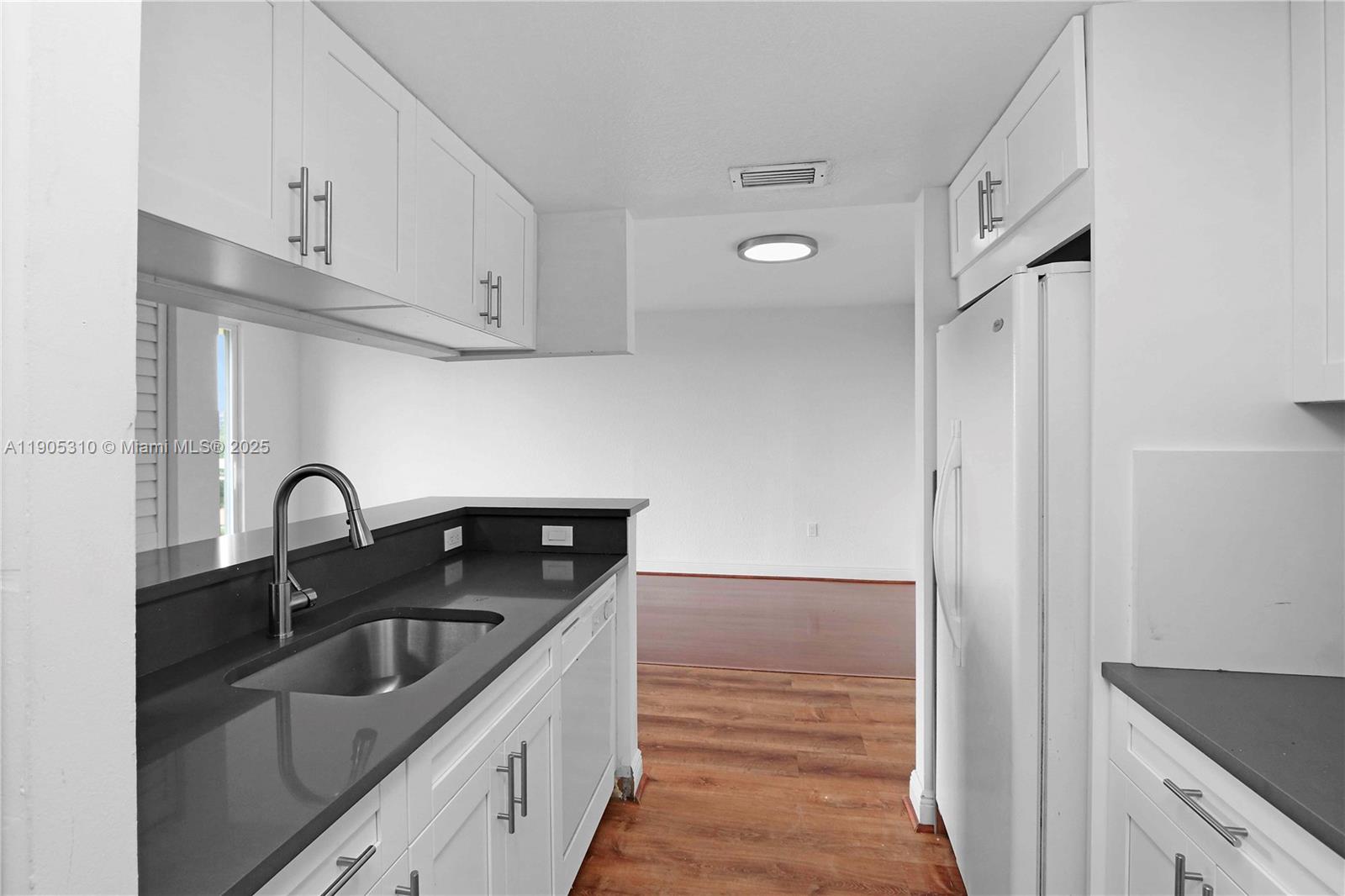 816 Northwest 11th Street, Unit 610 Miami, FL 33136 - Photo 18 of 28 a kitchen with stainless steel appliances granite countertop a sink stove and refrigerator