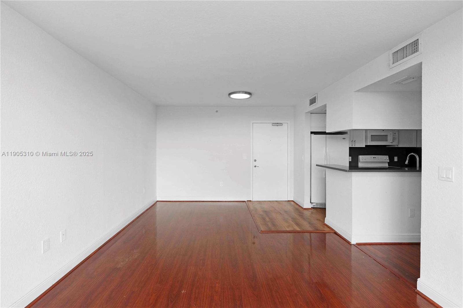 816 Northwest 11th Street, Unit 610 Miami, FL 33136 - Photo 19 of 28 a view of kitchen with wooden floor and electronic appliances