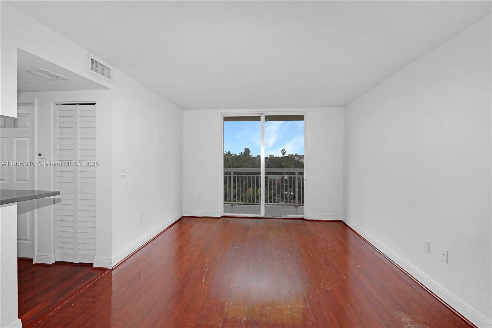 816 Northwest 11th Street, Unit 610 Miami, FL 33136 - Photo 20 of 28 an empty room with wooden floor and windows