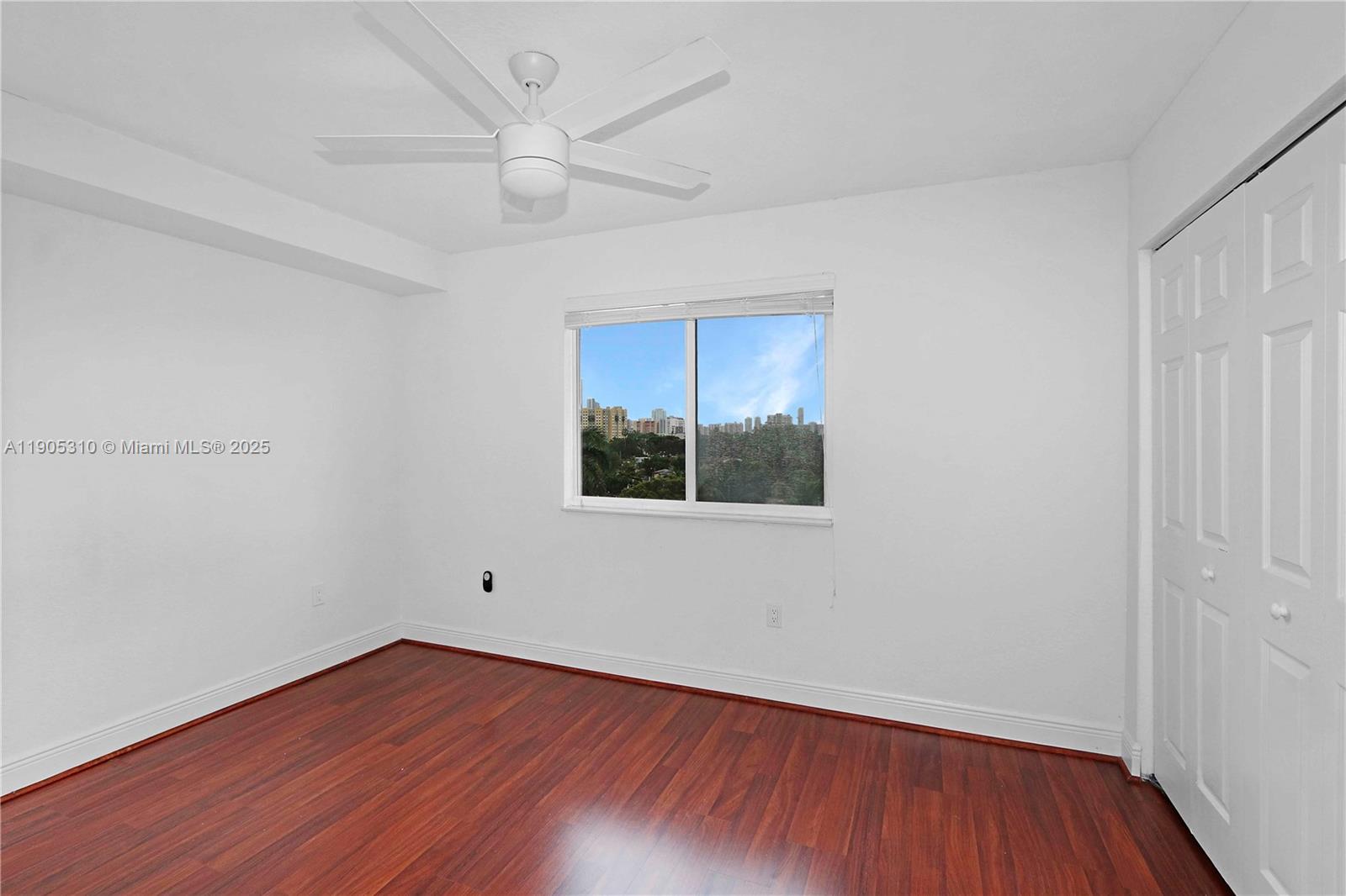816 Northwest 11th Street, Unit 610 Miami, FL 33136 - Photo 7 of 28 wooden floor in an empty room with a window