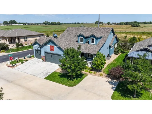 an aerial view of a house with garden space and ocean view