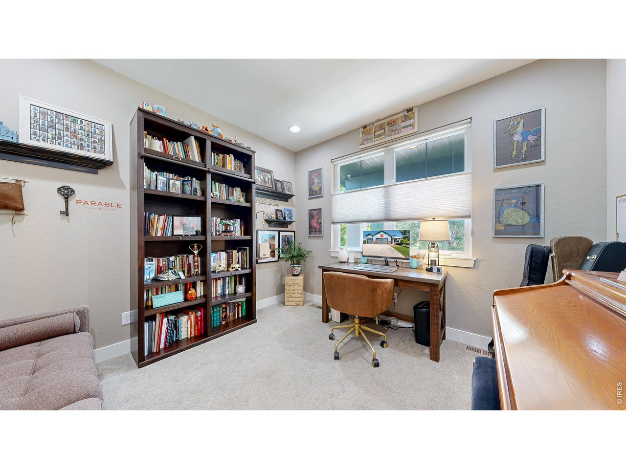 6990 Toponas Court Timnath, CO 80547 - Photo 12 of 44 a living room with furniture and a book shelf