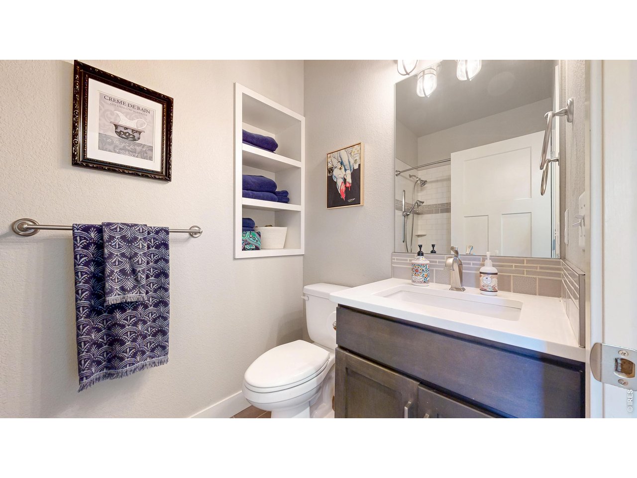 6990 Toponas Court Timnath, CO 80547 - Photo 19 of 44 a bathroom with a sink a toilet a shower and a mirror
