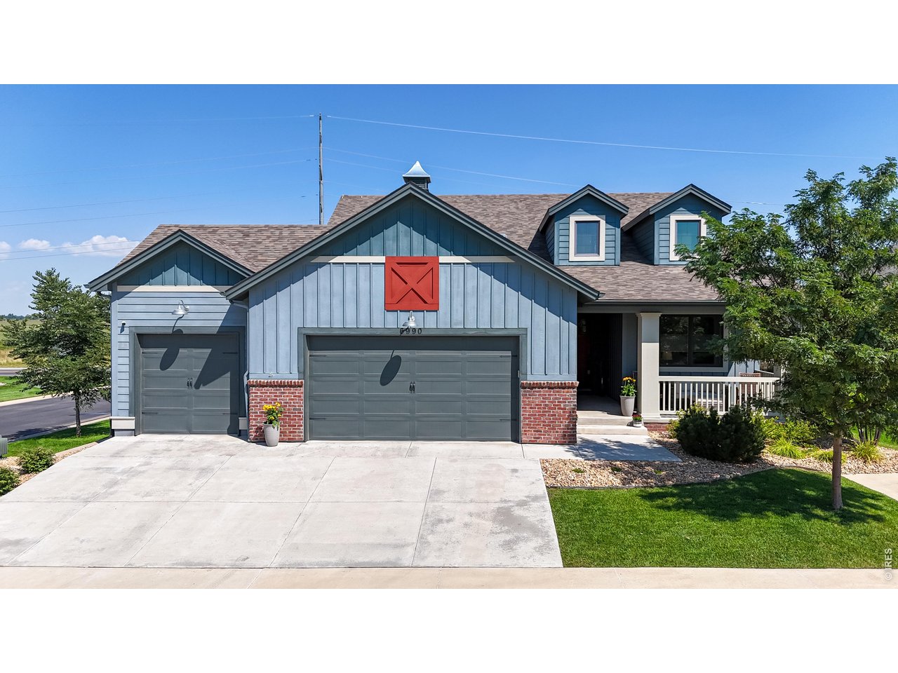 6990 Toponas Court Timnath, CO 80547 - Photo 2 of 44 a front view of a house with a yard and garage