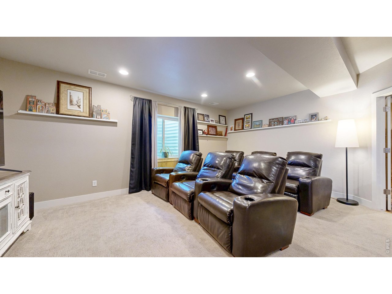 6990 Toponas Court Timnath, CO 80547 - Photo 23 of 44 a living room with furniture and a flat screen tv