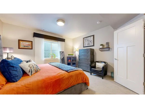 a bedroom with a bed and dresser