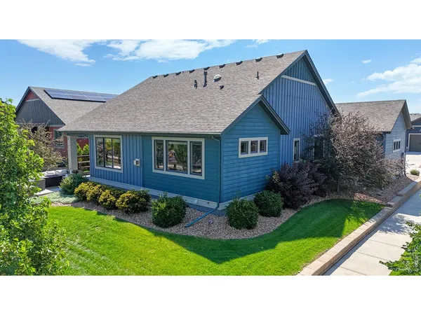 a black and white house with a yard