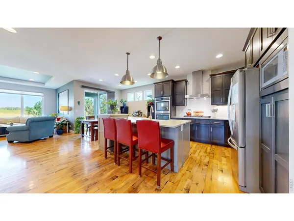 a living room with stainless steel appliances kitchen island granite countertop furniture