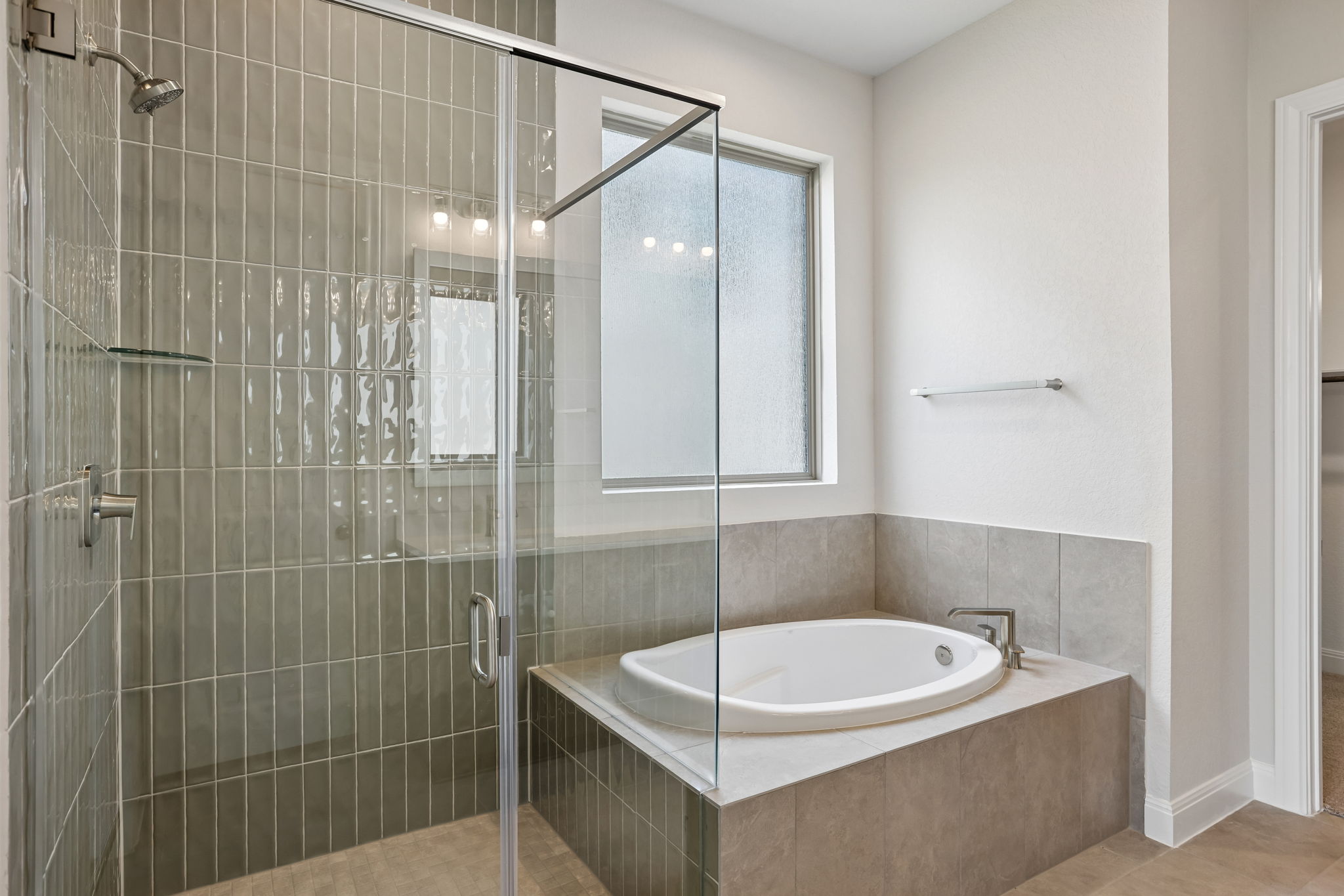 214 Prickly Poppy Loop Kyle, TX 78640 - Photo 22 of 38 a bathroom with a tub a sink and shower