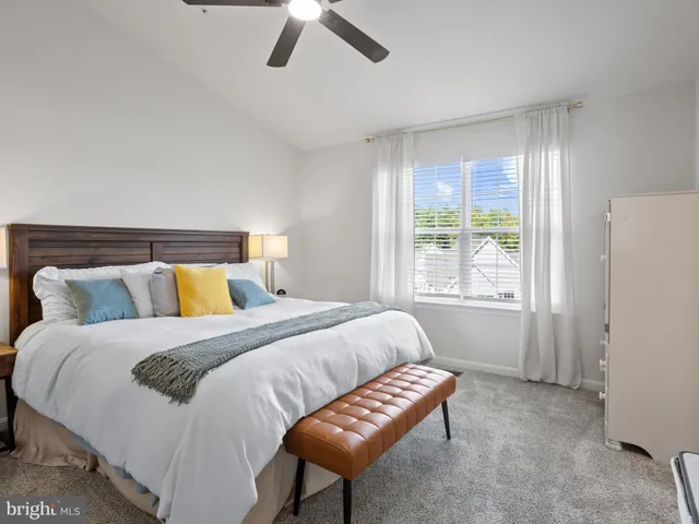 a bedroom with a bed and a chair