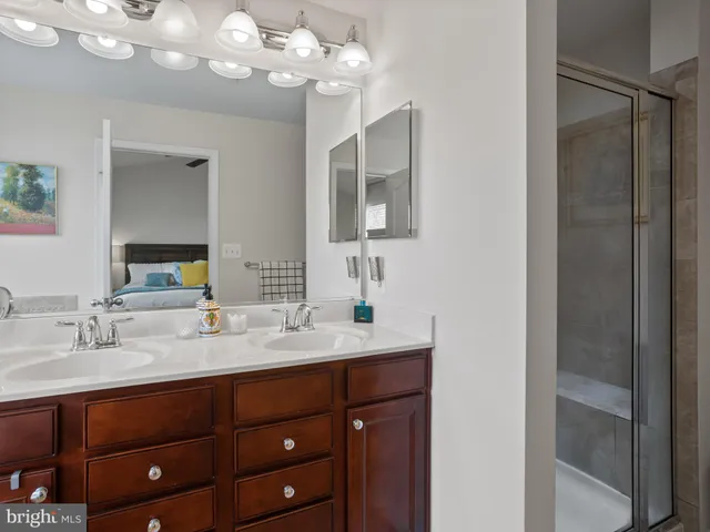 a bathroom with a sink vanity and a mirror