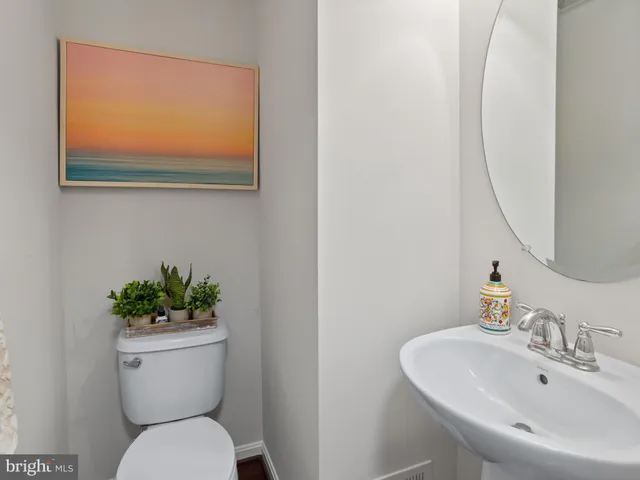 a bathroom with a toilet a sink and a mirror
