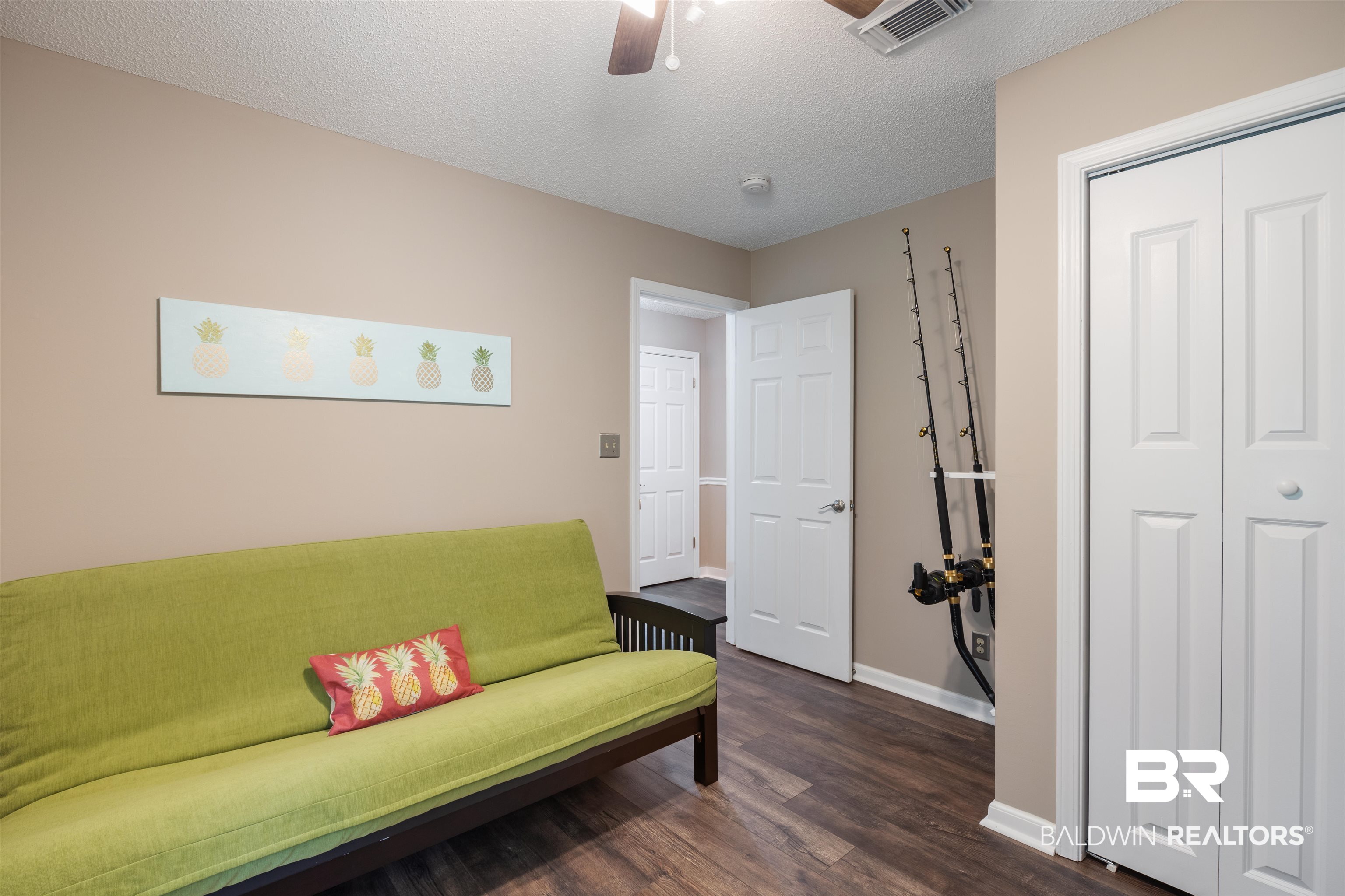 9771 Clarke Ridge Road Foley, AL 36535 - Photo 47 of 72 Sitting room with a textured ceiling, baseboards, and ceiling fan.