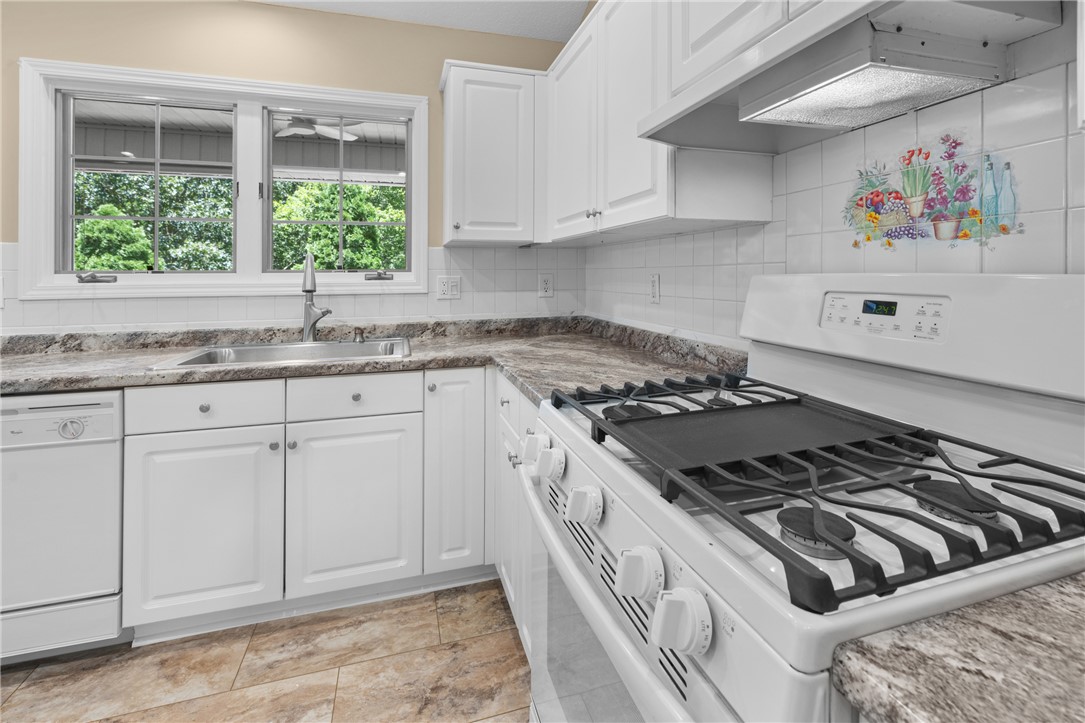 429 Burns Mill Road West Union, SC 29696 - Photo 14 of 49 A well-lit kitchen with ample counter space and garden views through a broad window.