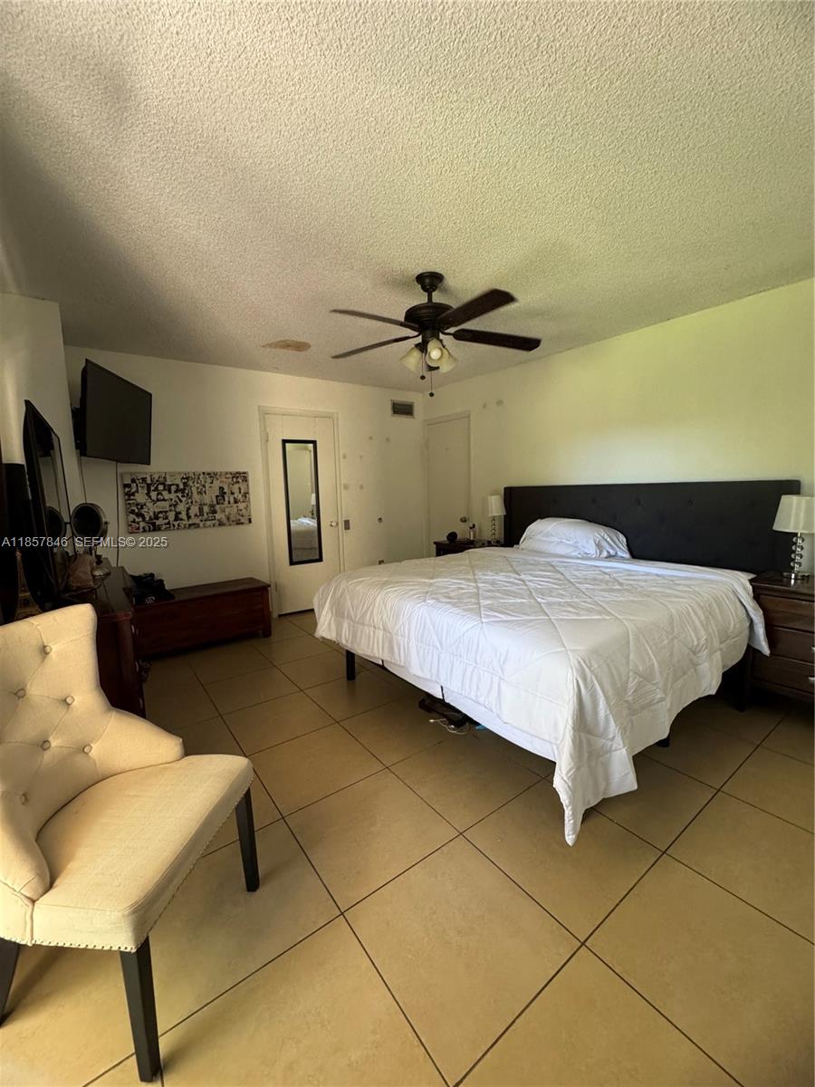 6445 Southwest 116th Place, Unit A Miami, FL 33173 - Photo 13 of 25 a bedroom with a bed and a couch