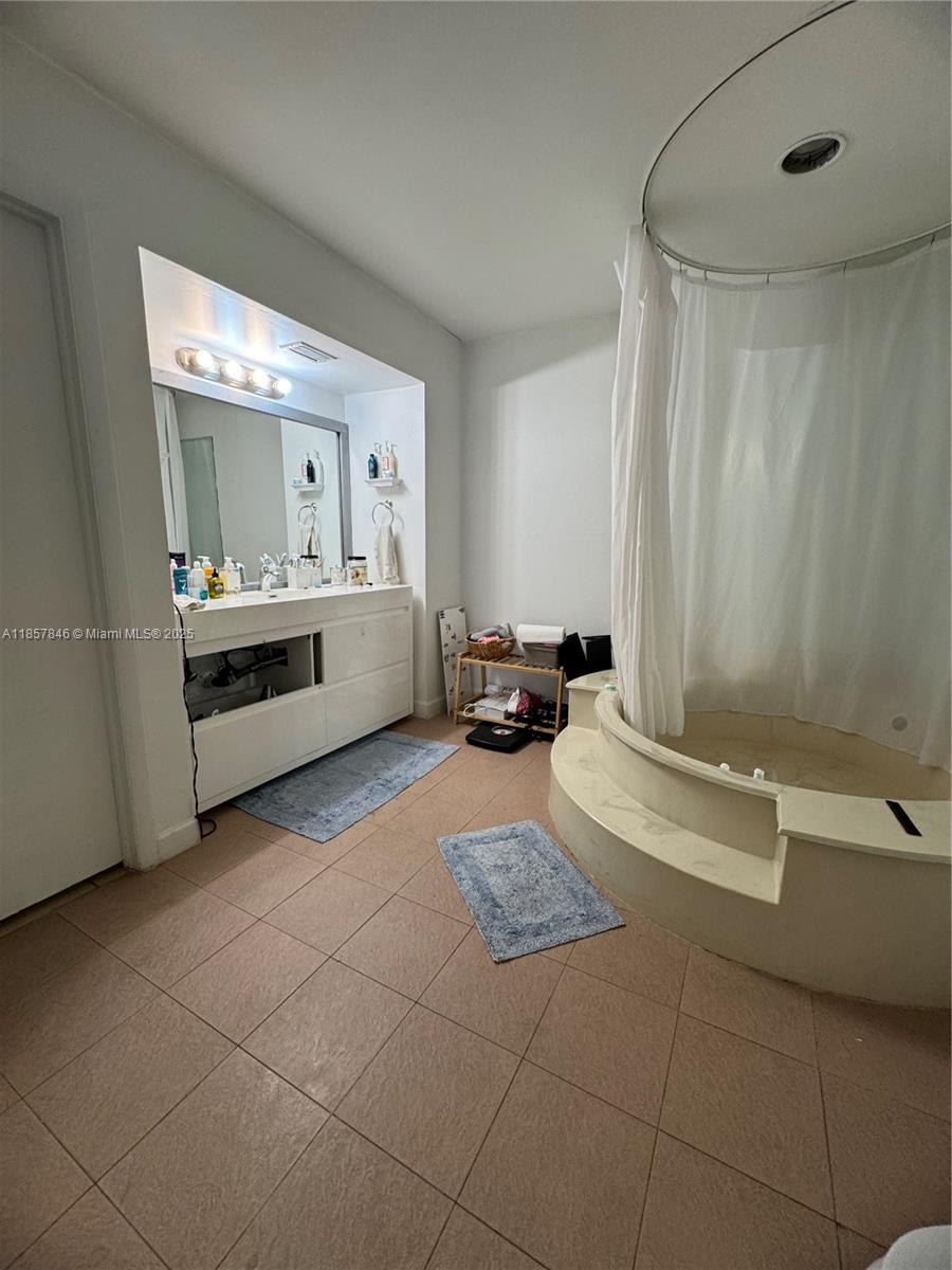 6445 Southwest 116th Place, Unit A Miami, FL 33173 - Photo 17 of 25 a bathroom with a tub sink and mirror