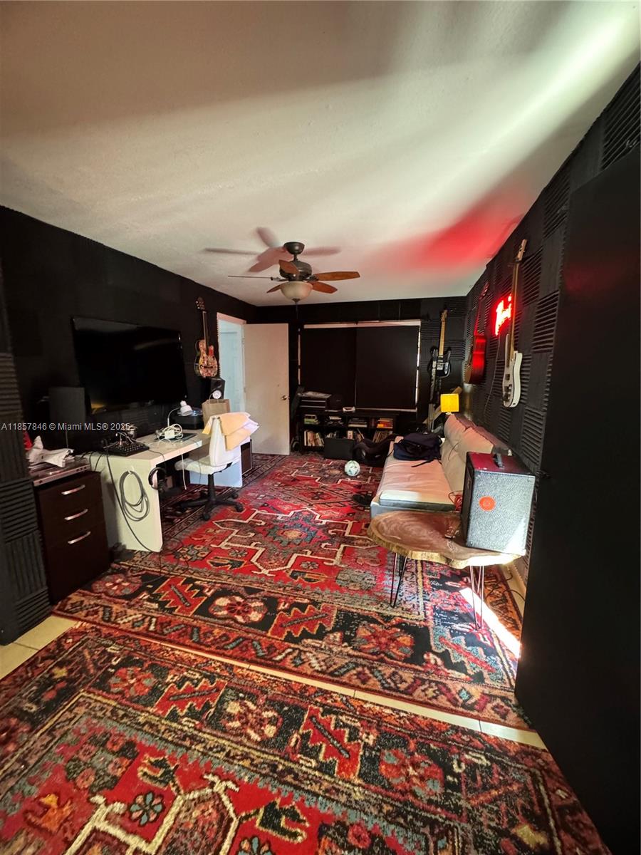 6445 Southwest 116th Place, Unit A Miami, FL 33173 - Photo 23 of 25 a living room with lots of furniture and a flat screen tv