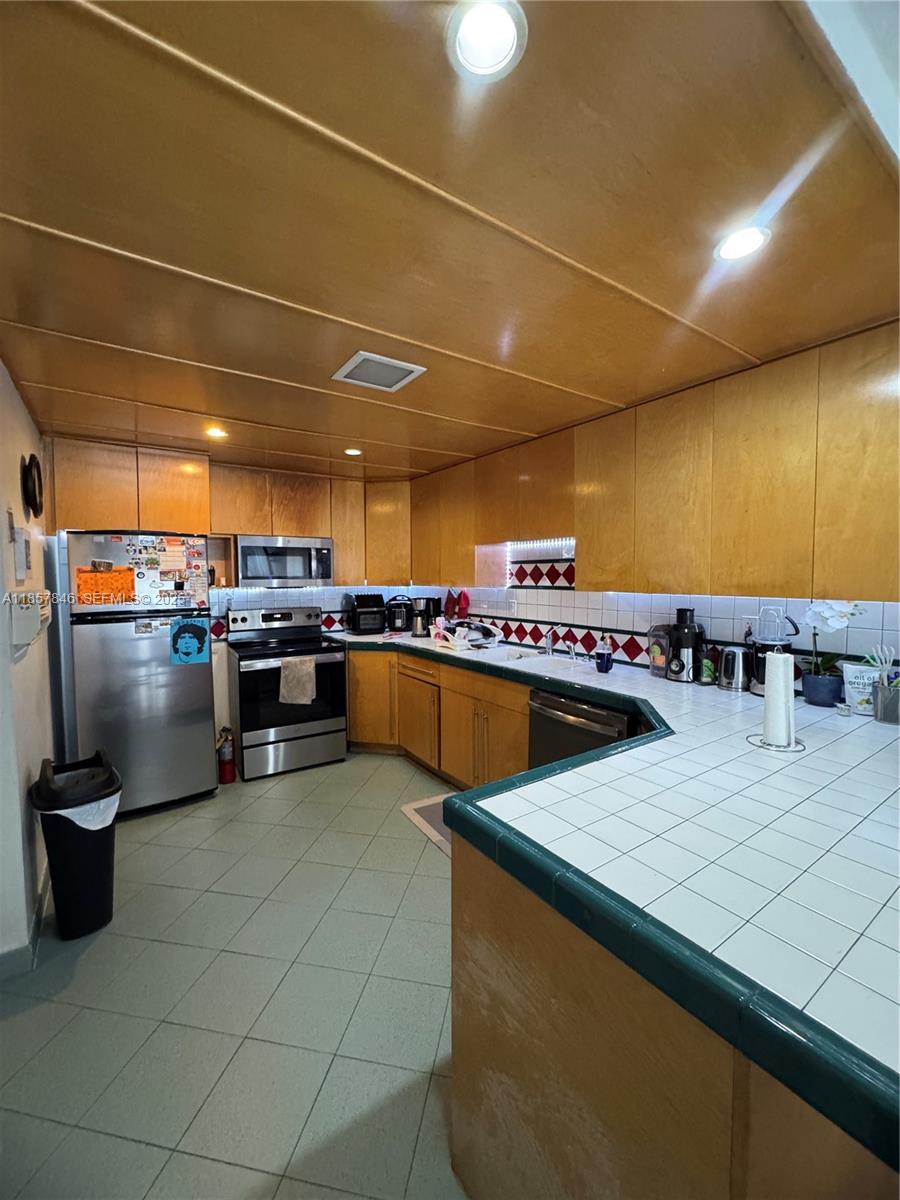 6445 Southwest 116th Place, Unit A Miami, FL 33173 - Photo 5 of 25 a view of a kitchen with a sink and dishwasher