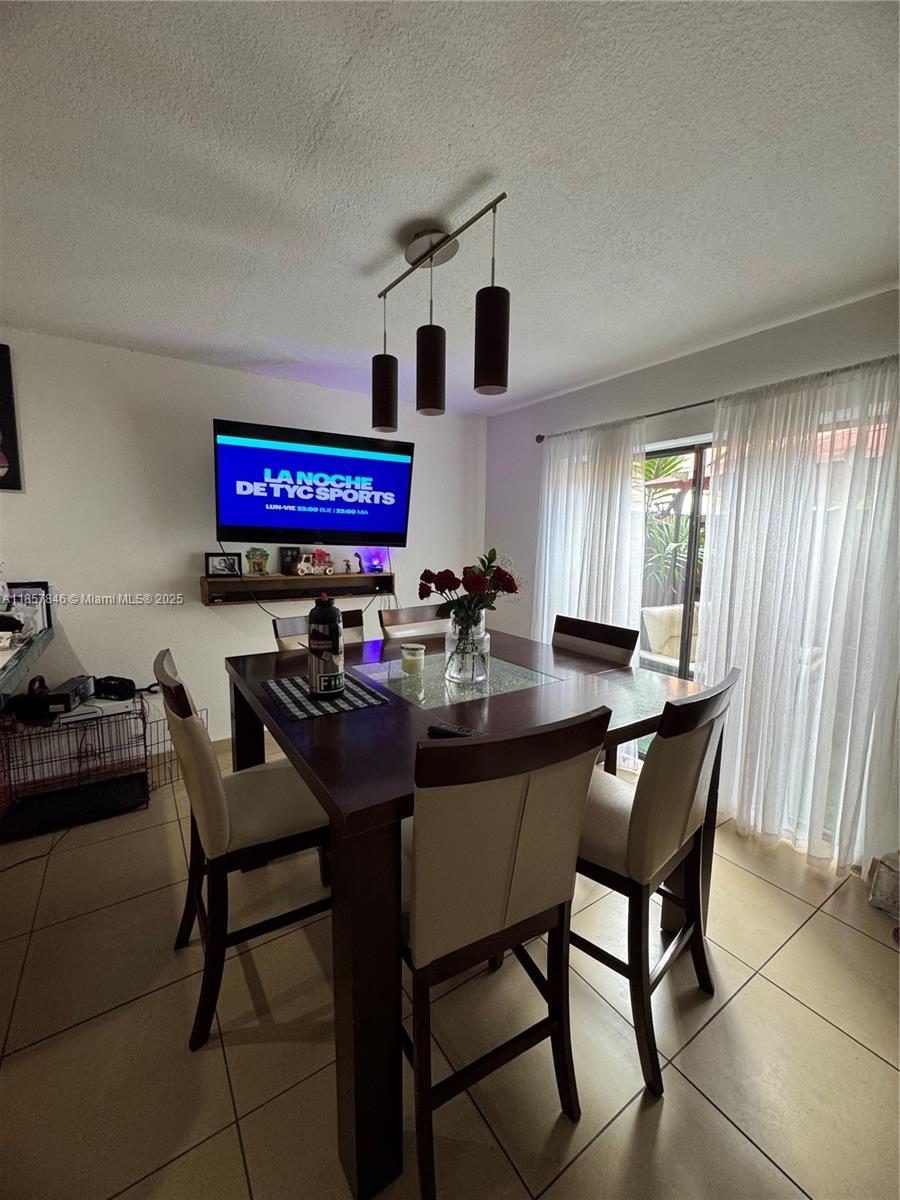 6445 Southwest 116th Place, Unit A Miami, FL 33173 - Photo 7 of 25 a living room with furniture and a large window