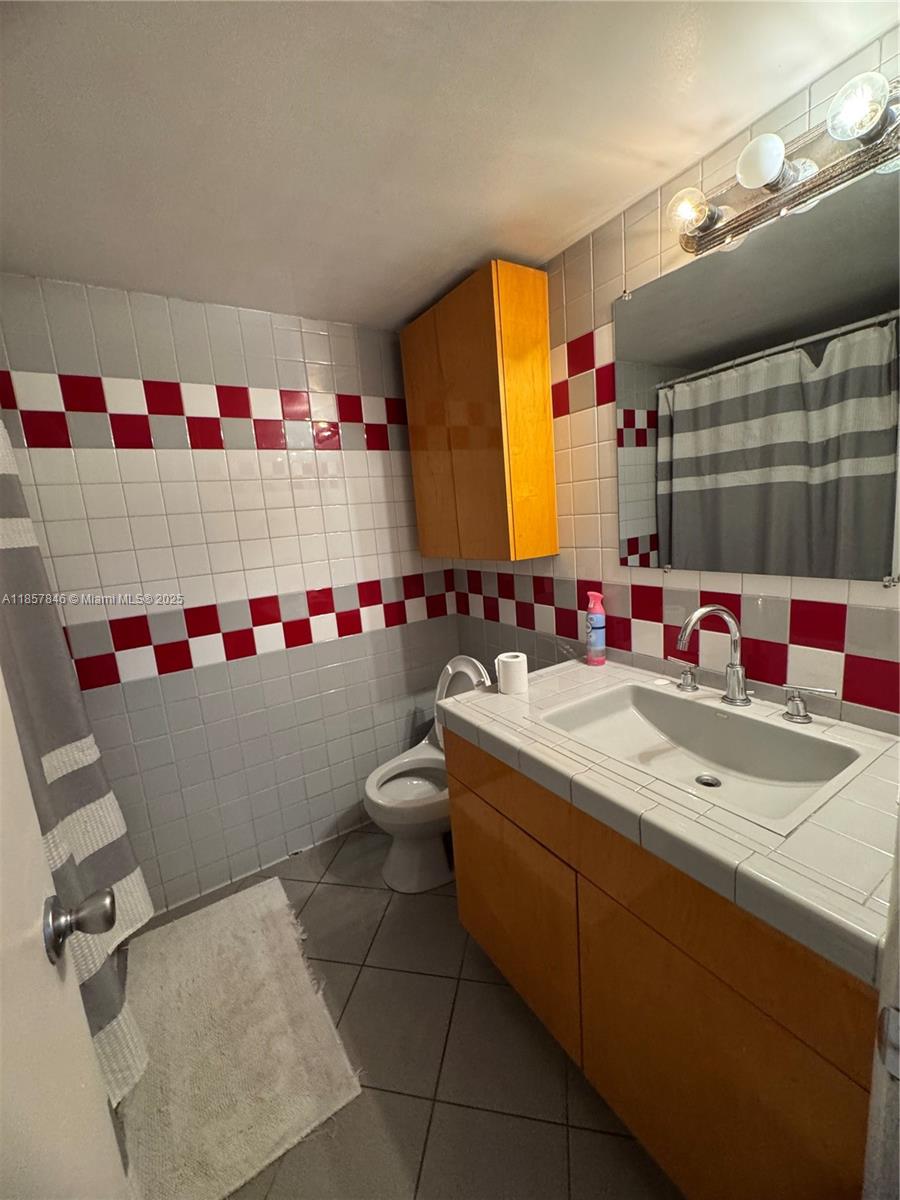 6445 Southwest 116th Place, Unit A Miami, FL 33173 - Photo 9 of 25 a bathroom with a sink and a mirror