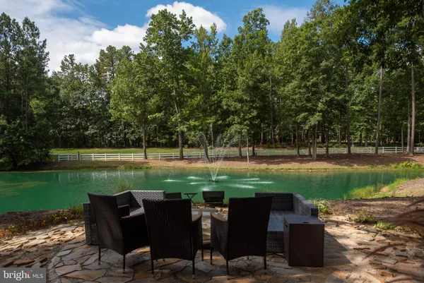 a living room with furniture a rug and a fireplace