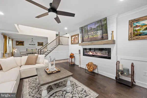 a living room with furniture and floor to ceiling windows