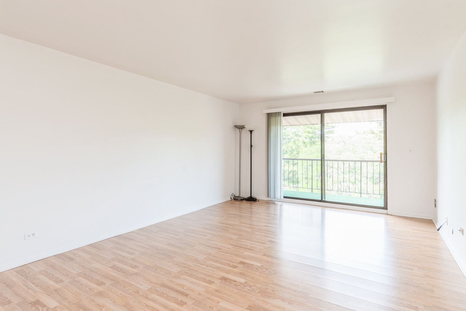 709 79th Street, Unit 401 Darien, IL 60561 - Photo 11 of 20 an empty room with wooden floor and windows