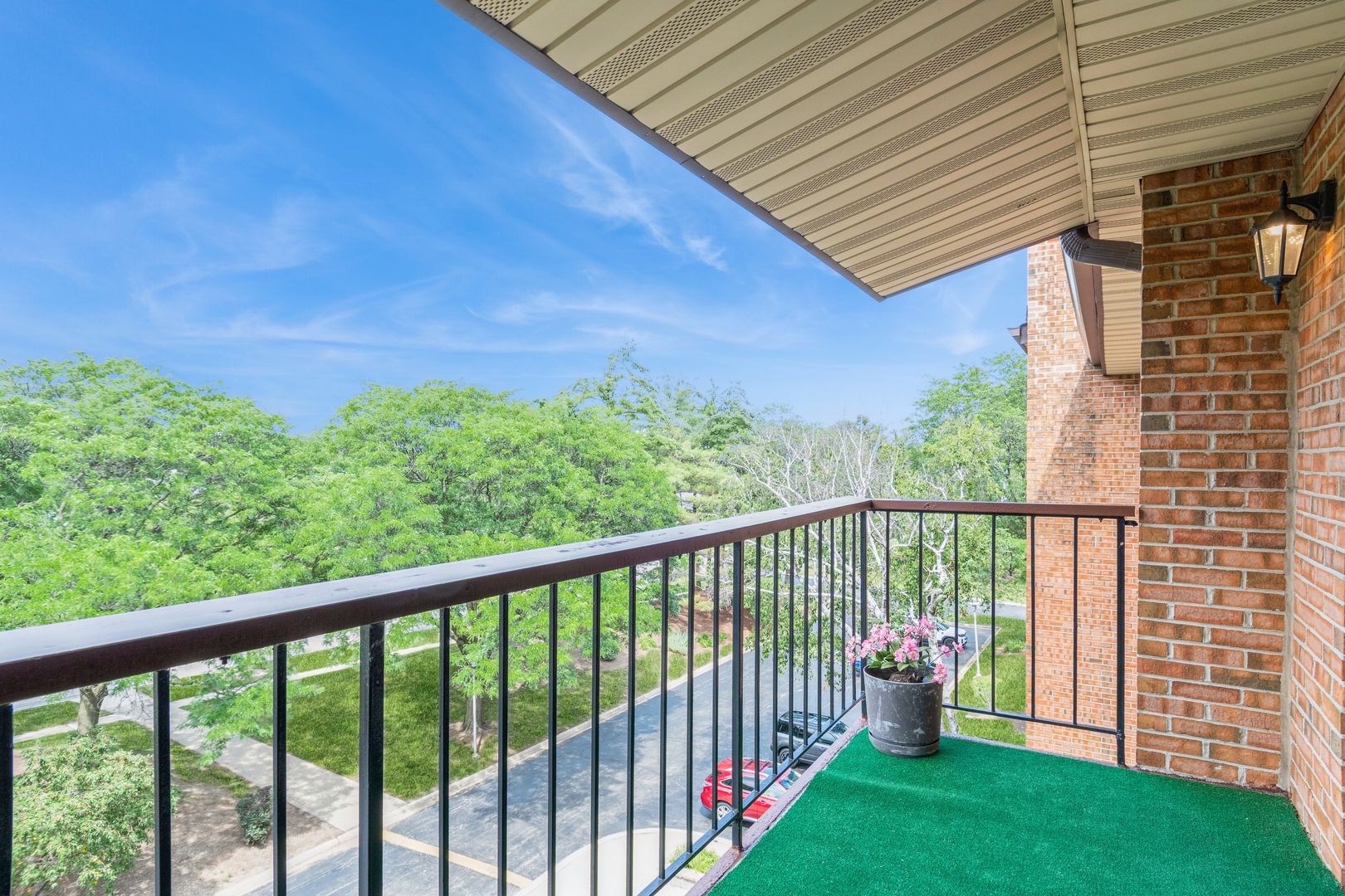 709 79th Street, Unit 401 Darien, IL 60561 - Photo 16 of 20 a view of a chair and table in the balcony