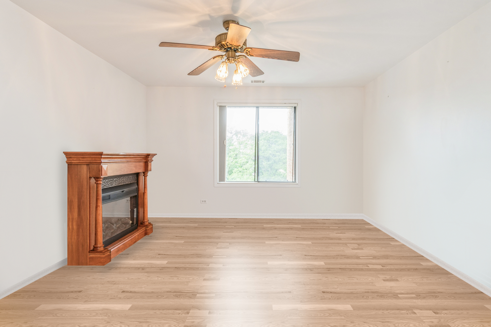 709 79th Street, Unit 401 Darien, IL 60561 - Photo 18 of 20 a view of an empty room with a window and wooden floor