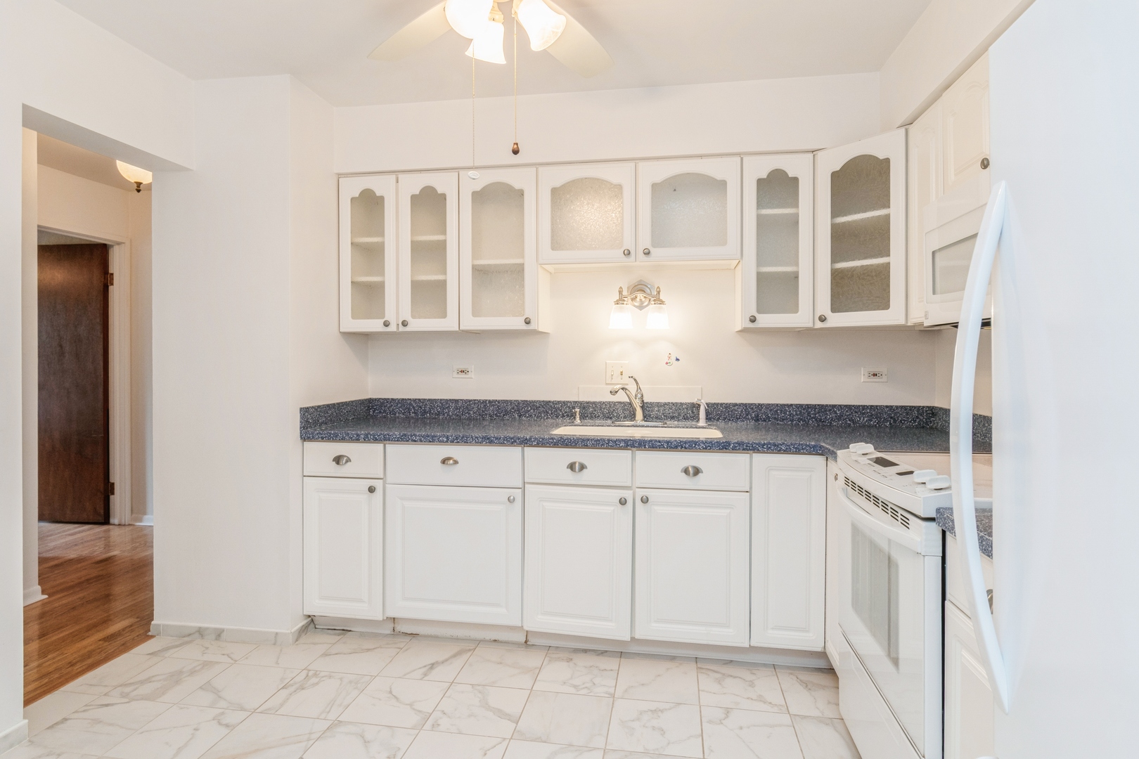 709 79th Street, Unit 401 Darien, IL 60561 - Photo 4 of 20 a kitchen with stainless steel appliances granite countertop a sink and cabinets