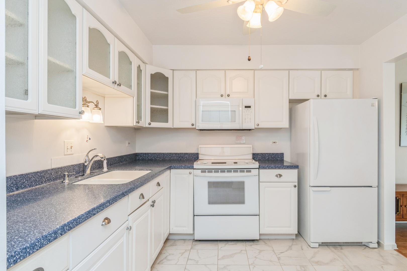 709 79th Street, Unit 401 Darien, IL 60561 - Photo 5 of 20 a kitchen with cabinets appliances and a sink