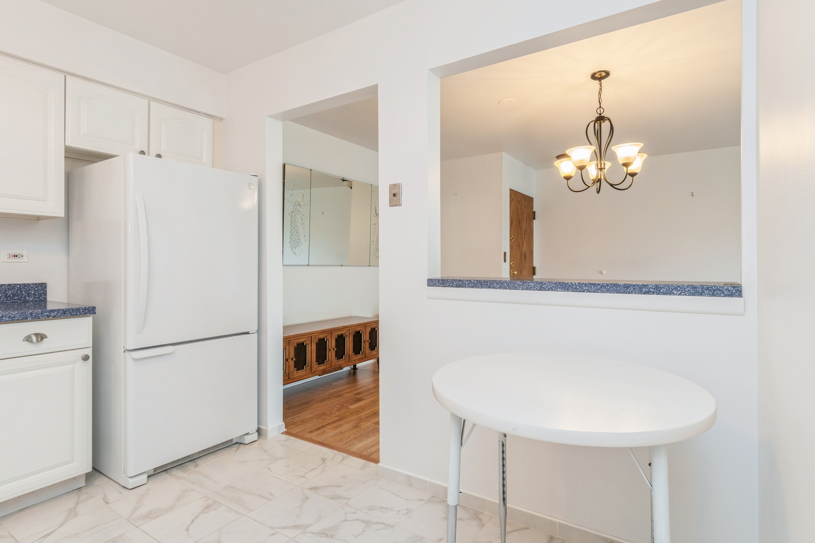 709 79th Street, Unit 401 Darien, IL 60561 - Photo 6 of 20 a kitchen with stainless steel appliances a refrigerator and a chandelier