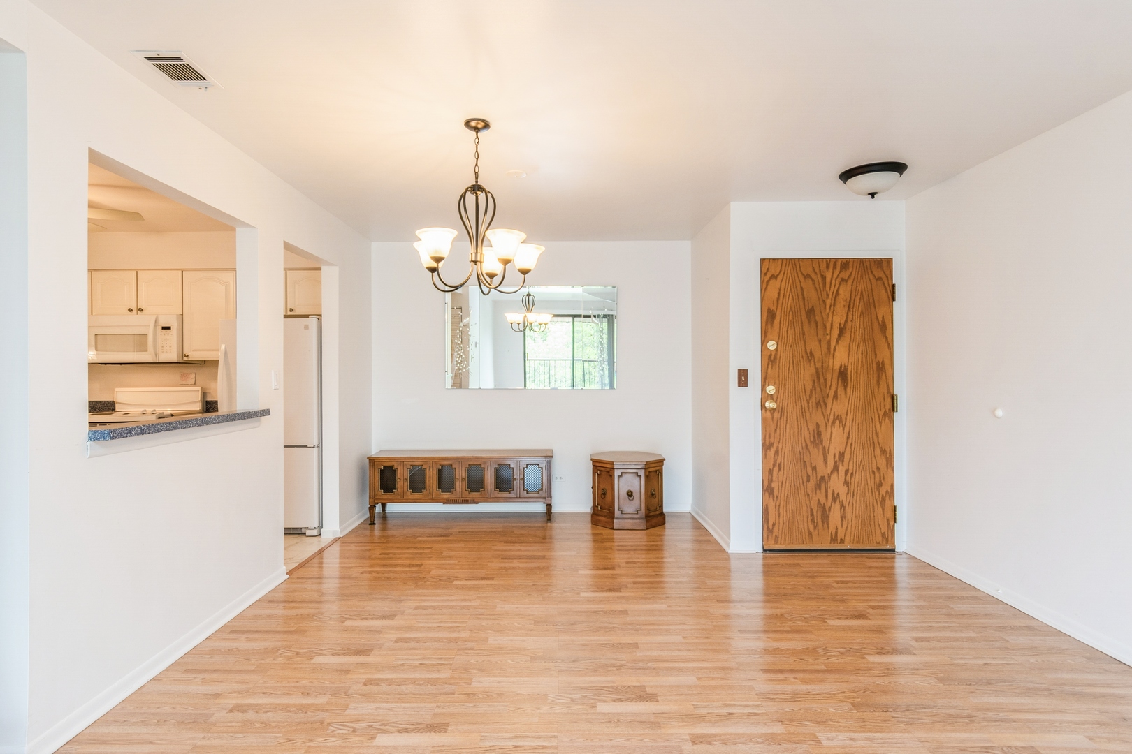 709 79th Street, Unit 401 Darien, IL 60561 - Photo 8 of 20 a view of a livingroom with wooden floor and a chandelier