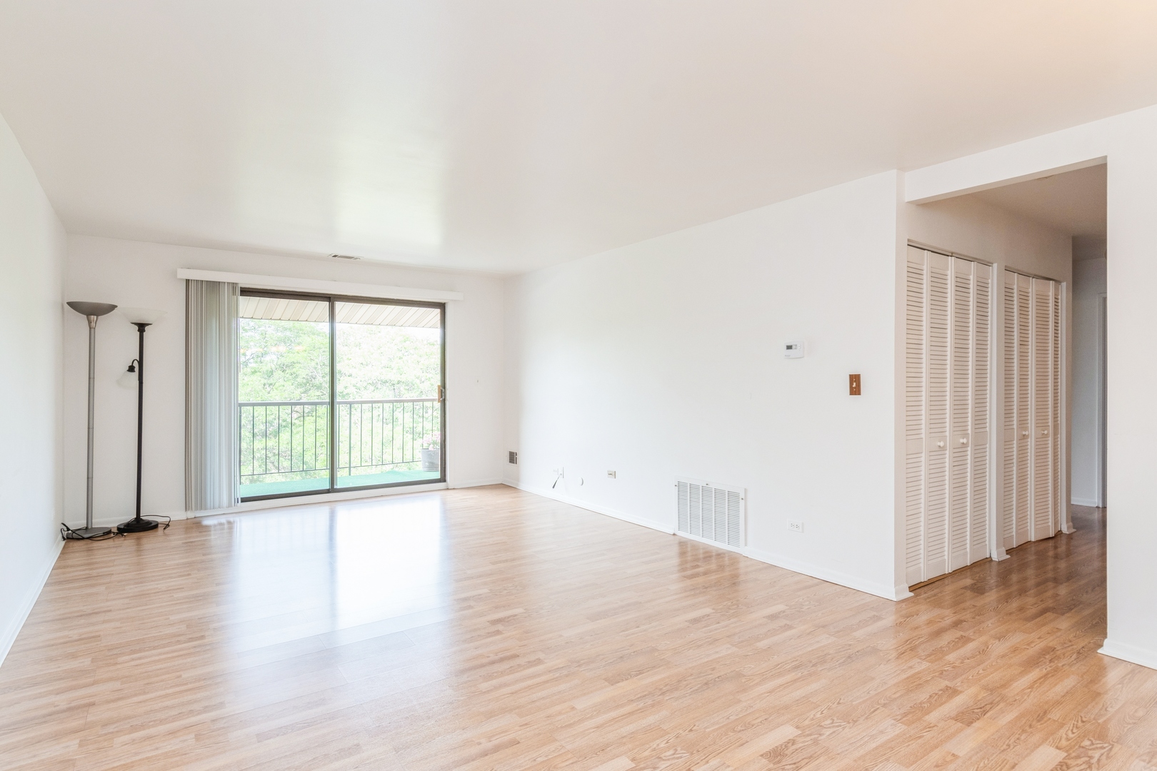 709 79th Street, Unit 401 Darien, IL 60561 - Photo 10 of 20 a view of an empty room with wooden floor and a window