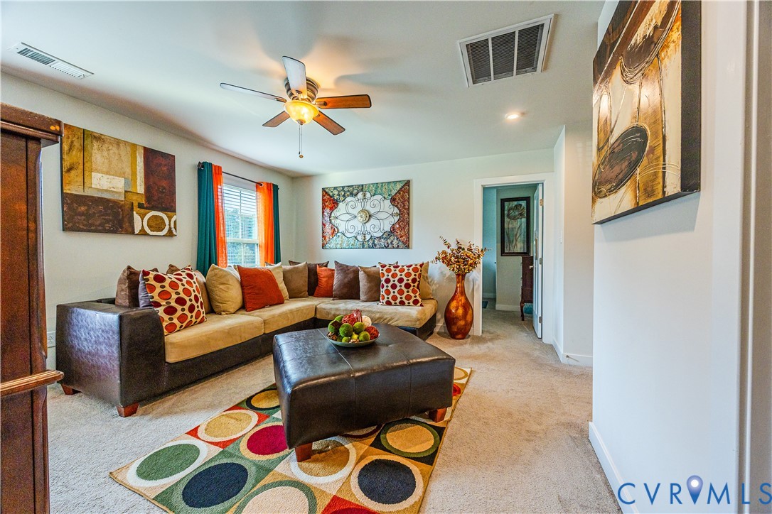 4331 Ganymede Drive Chester, VA 23831 - Photo 18 of 40 a living room with furniture and a rug