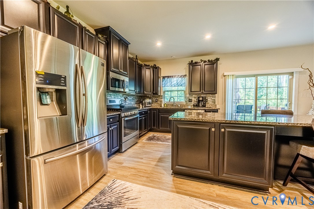 4331 Ganymede Drive Chester, VA 23831 - Photo 10 of 40 a kitchen with stainless steel appliances granite countertop a refrigerator a sink a stove and oven